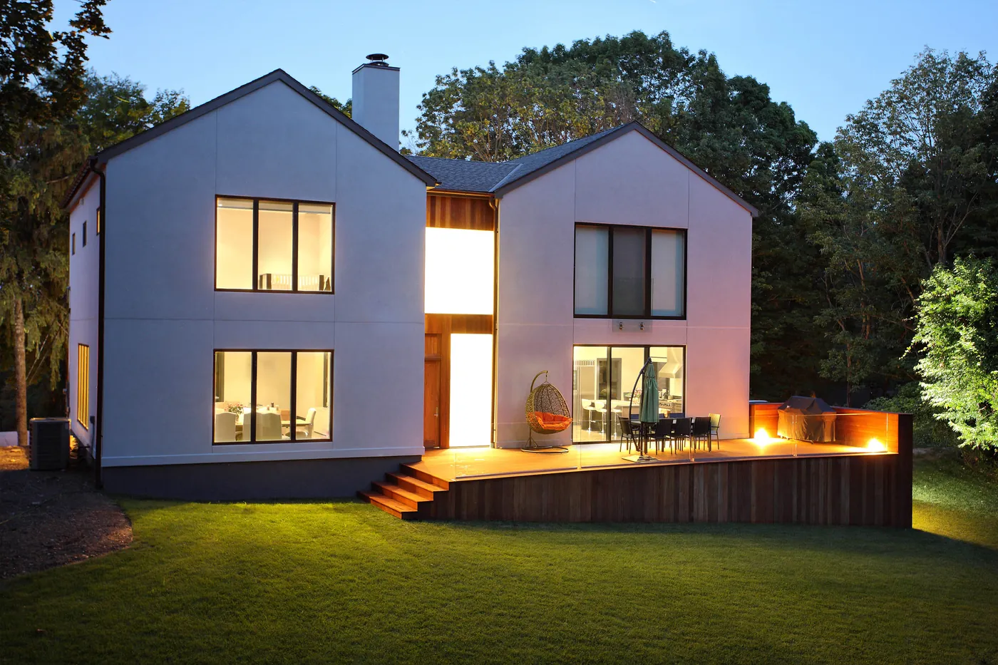 Modern house with exterior and garden lighting at dusk